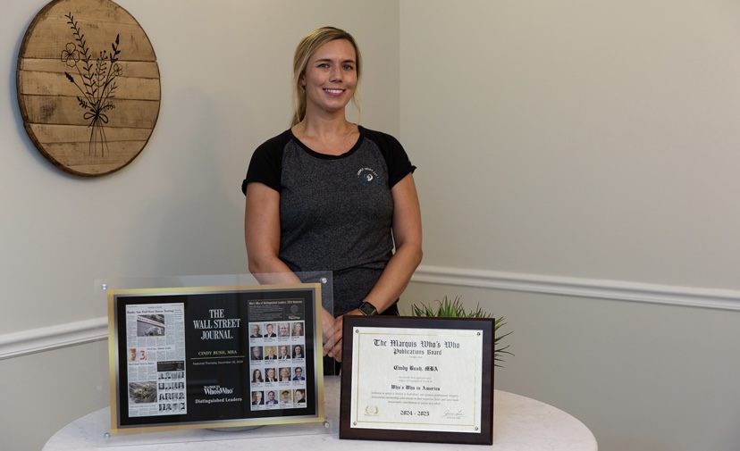 Cindy Bush with her Wall Street Journal feature and Marquis Who's Who certificate